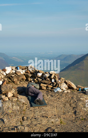 A hiker wild camping on the summit of Robinson, Buttermerei in the Lake District. Stock Photo