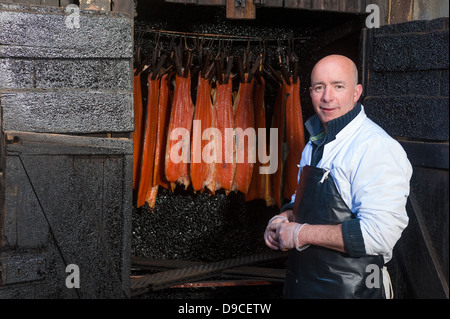 Worker smoking salmon Stock Photo