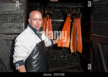 Worker smoking salmon Stock Photo