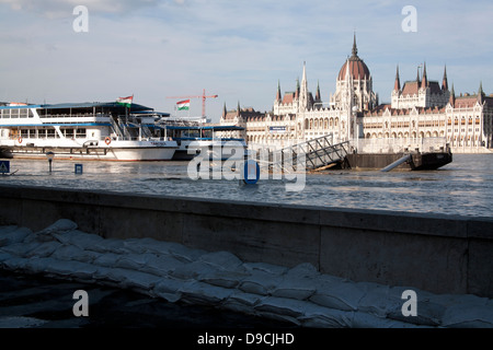 Police cordon and closed street overlooking the parliament building on the flooded banks of the River Danube, Budapest, Hungary Stock Photo