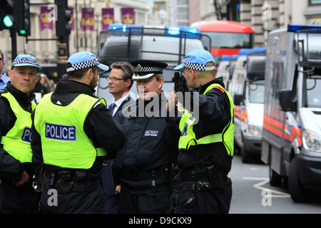 Territorial support group (TSG) officers wait in front of the Houses ...