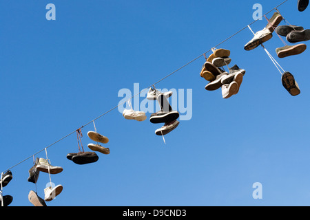 Shoes on a power supply line, Shoes on a power line, Stock Photo