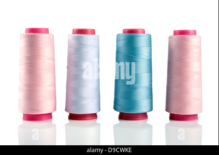 Some plastic spools with multicoloured threads isolated on white Stock Photo