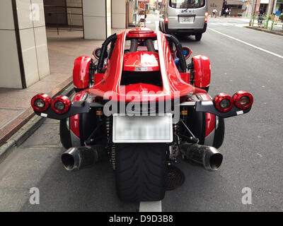 Campagna T-Rex 14R: June 17, 2013, Tokyo, Japan: Three-wheeled vehicle Campagna T-Rex 14R is parked in the Ginza area in Tokyo, Japan. The eccentric vehicle is produced by the Montreal based Campagna Motors team. One of the two vehicles produced by the Canadian company, the T-Rex 14R is powered by a Kawasaki 1400cc engine, and claims to put together the comfort of a traditional car with the speed sensation of a fast motorbike. The T-Rex can be bought and customized directly from the producer website, and its price starts from 59,999USD. (Photo by Francesco Libassi/AFLO) Stock Photo