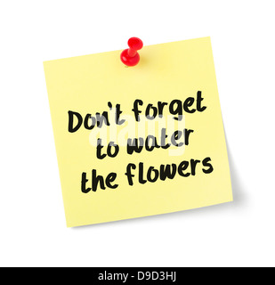 Yellow paper note with text Dont forget to water the flowers Stock Photo