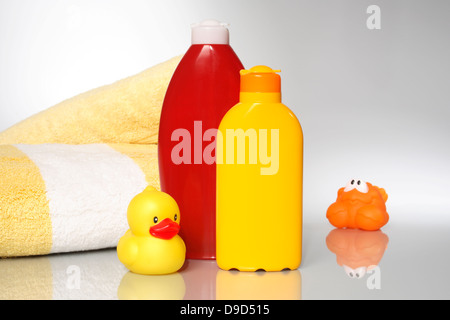 Bath sheets, solar milk, nursing cream and elastic animals Stock Photo