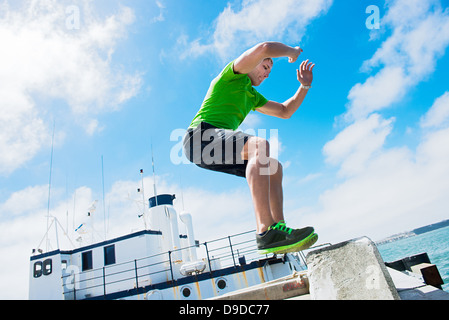 Young man jumping while fitness training Stock Photo