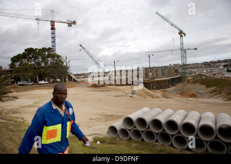 A worker knocks off work end day on construction site Nelson Mandela Bay Stadium in Port Elizabeth stadium in Eastern Cape will Stock Photo