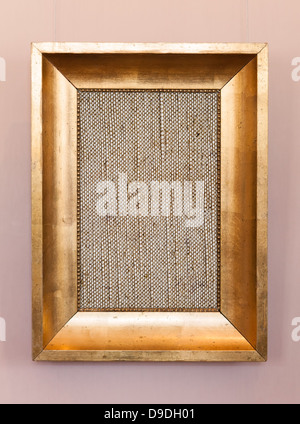 Old classical wooden frame with blank canvas on hanging the wall Stock Photo