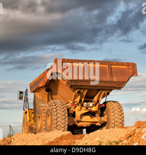 Heavy dump truck on a construction of new roads Stock Photo