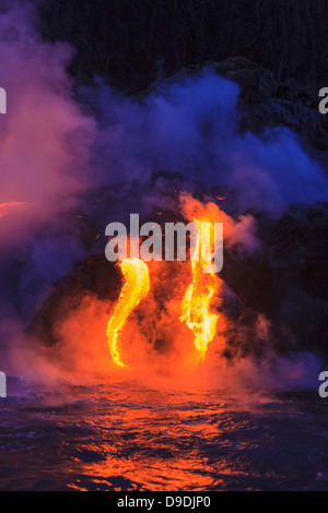 Lava flow impacting sea at dusk, Kilauea volcano, Hawaii Stock Photo