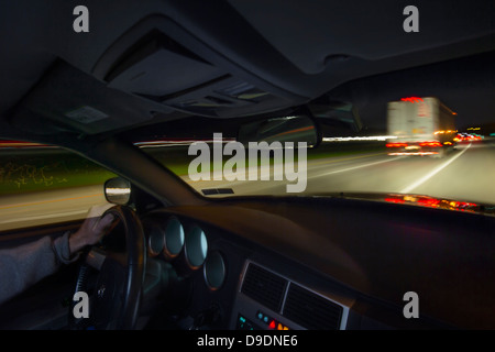 Driving At Night on Highway Stock Photo