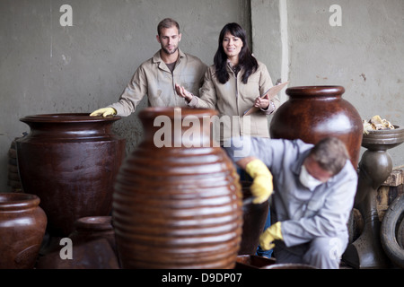 Painting and staining process in pottery factory Stock Photo