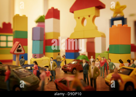 Toy cars and figurines in pretend plastic block town Stock Photo