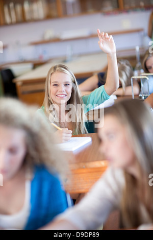 Student putting her hands up