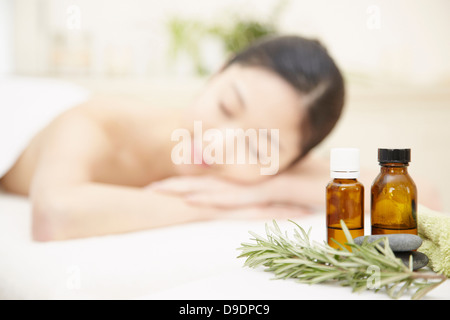 Aromatherapy oils with woman in background Stock Photo