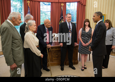 President Barack Obama talks with Rep. John Dingell, D-Mich., along with members of his family, in the Oval Office, June 13, 201 Stock Photo