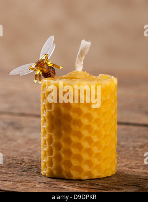 Beeswax candles on wooden table Stock Photo