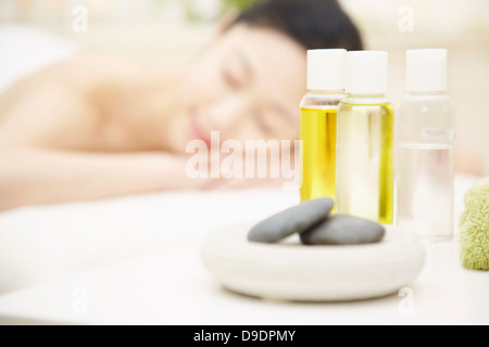 Aromatherapy oils with woman in background Stock Photo