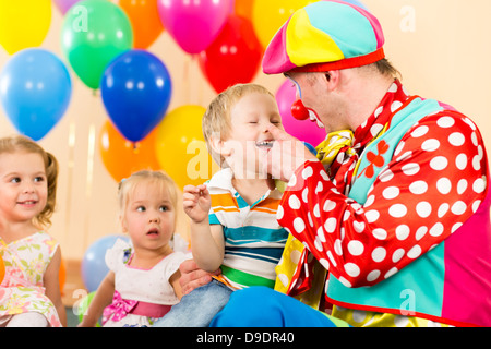 Premium Photo  Cute little boy with clown makeup in rainbow wig indoors.  april fool's day celebration