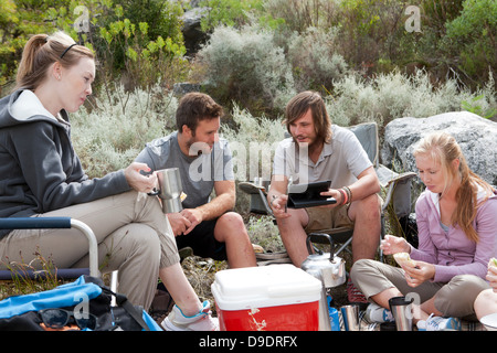 Group of young hikers taking a lunch break Stock Photo