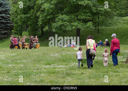 Kelvingrove Park, Glasgow, Scotland, UK, 18th June 2013. Big Peat Drums and Bagpipes traditional Scottish band play music for the locals while recording a new video. Big Peat can usually be seen in Buchanan Street in Glasgow and are quite a famous group. Paul Stewart/Alamy Live News Stock Photo