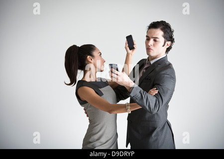 Business couple using smartphones Stock Photo