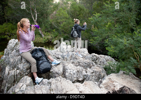 Girl hikers taking a break on rocks Stock Photo