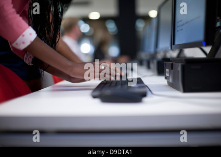 Female student using computer keyboard in class Stock Photo