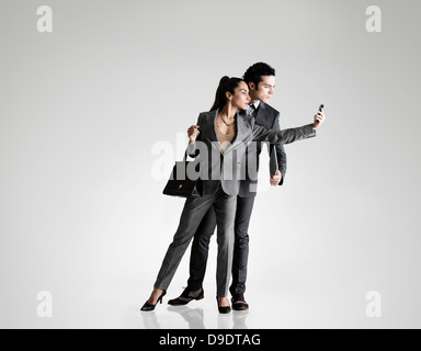 Business couple using cell phone Stock Photo