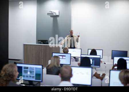 Students using computers in lecture Stock Photo