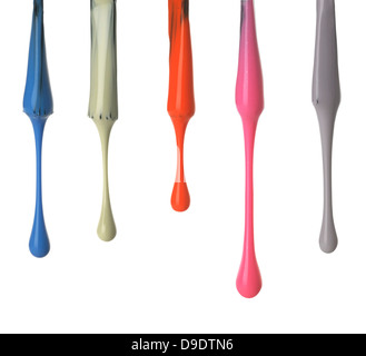 row of coloured nail polish brushes with drips in different colours cut out onto a white background Stock Photo