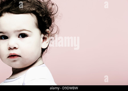 Portrait of baby girl against pink background Stock Photo