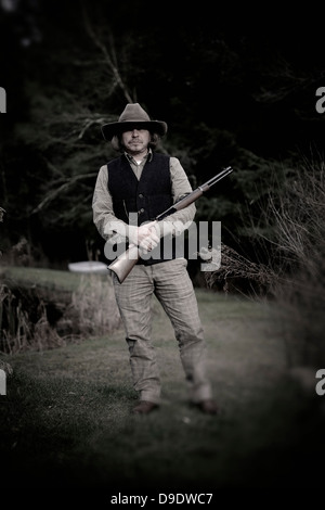 Portrait of a man with a gun Stock Photo