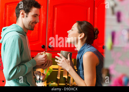 Young couple in kitchen with coffee cups Stock Photo