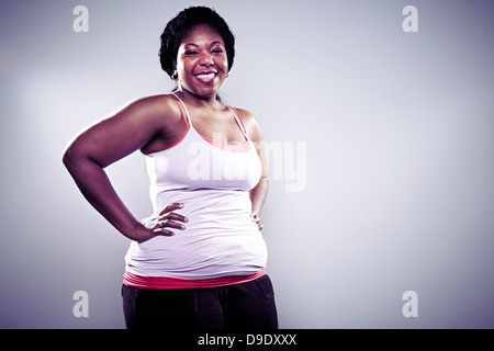 Young Woman Wearing White Briefs And Vest Hand On Hip Mid Section