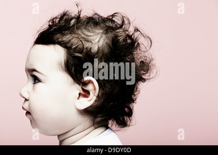 Portrait of baby girl against pink background Stock Photo