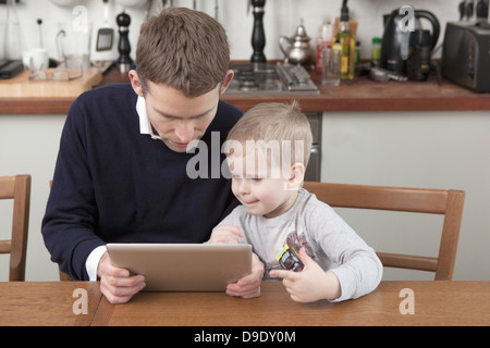 Father and son using digital tablet Stock Photo