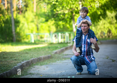 Portrait of father and son play outdoors Stock Photo