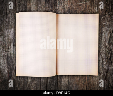 Open blank note book on grunge old wood background Stock Photo