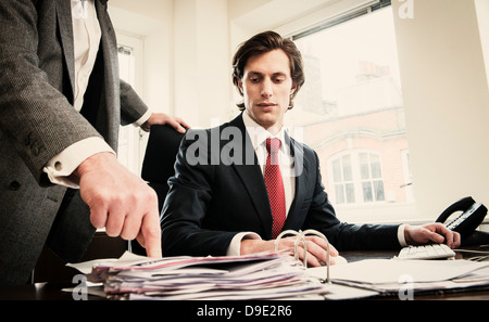 Man pointing at paperwork in ring binder Stock Photo