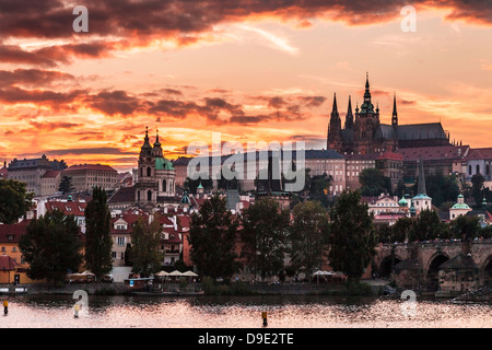 A fiery sunset over the River Vltava, the Castle, St Vitus Cathedral and Charles Bridge in Prague, Czech Republic. Stock Photo