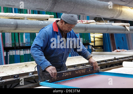Man screen printing in textiles factory Stock Photo