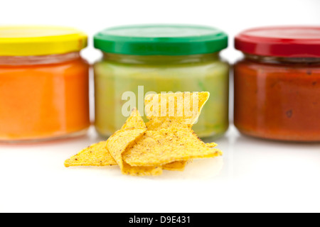 Traditional nacho chips and Mexican dips isolated on white background Stock Photo