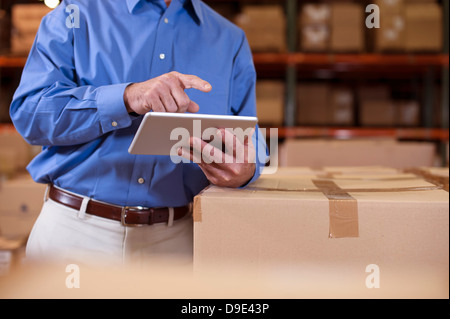 Male warehouse manager using digital tablet Stock Photo