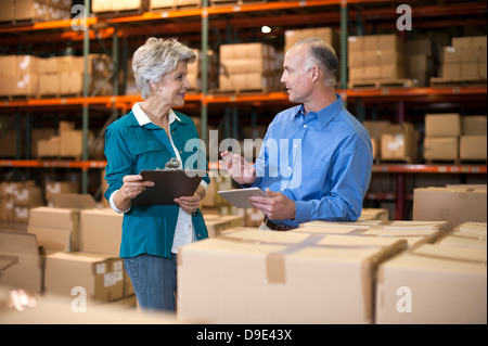 Warehouse workers using digital tablet Stock Photo