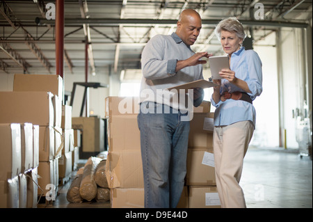 Warehouse workers using digital tablet Stock Photo