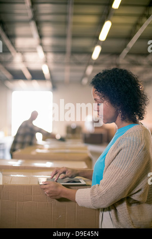 Female warehouse worker using digital tablet Stock Photo