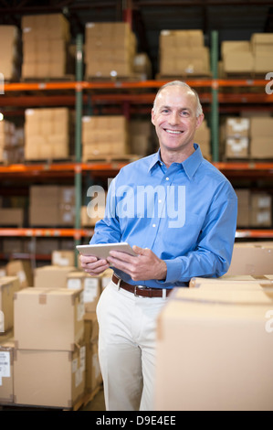 Portrait of female warehouse worker with digital tablet Stock Photo