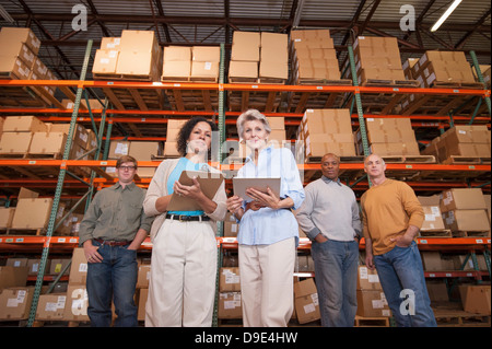 Portrait of warehouse workers in front of boxes Stock Photo